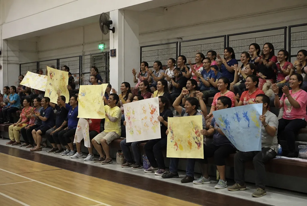 Parents cheering at an inter-school basketball game.