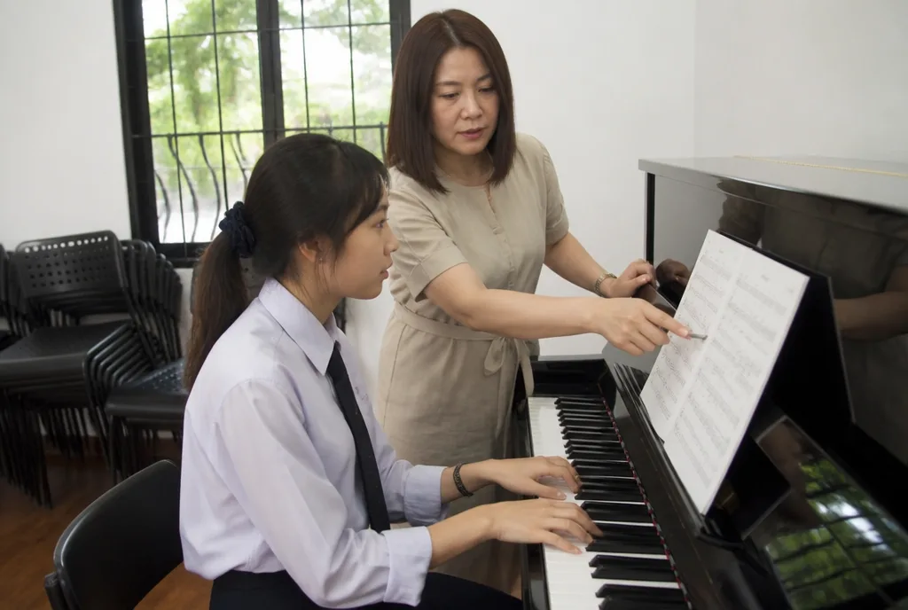 Lim Xin Yi rehearses her song with the music department.