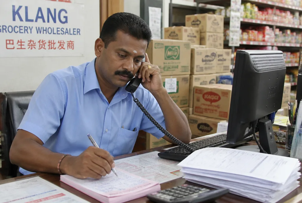 A Lian Tat trade account manager on a call at the order desk