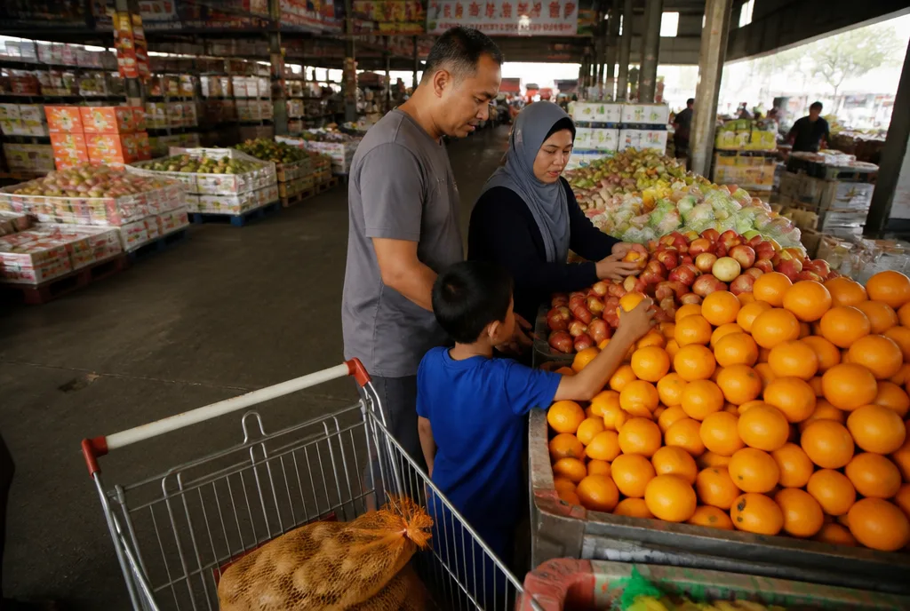 A family choosing fruit in the market hall