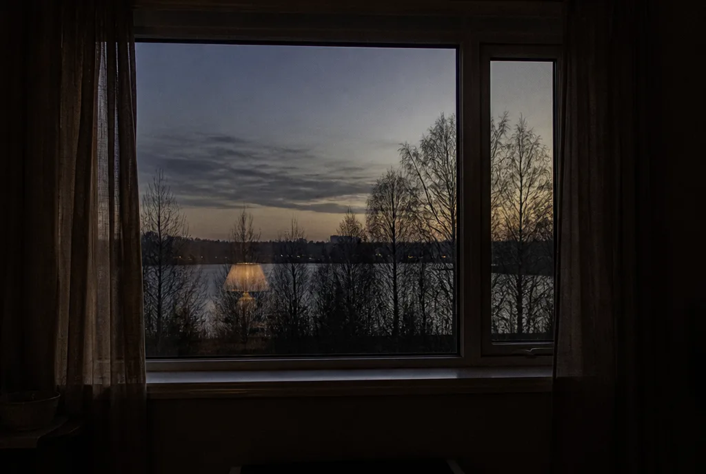 A window at dusk seen from inside a quiet room