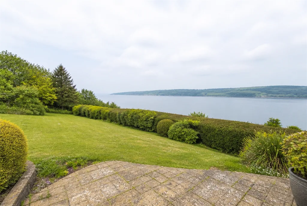 The rear garden at Empingham looking downhill towards the reservoir and low green hills