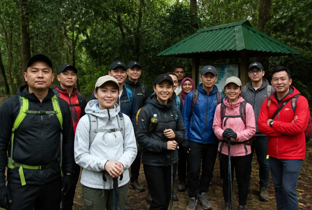A group at a trailhead looking to their leader