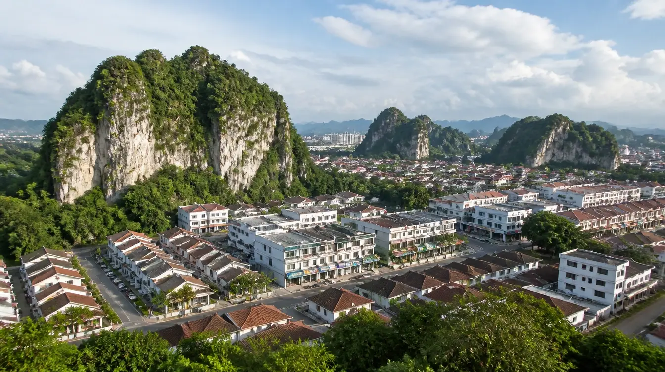 An overview of Ipoh Garden, suburban housing and shoplots below the limestone hills