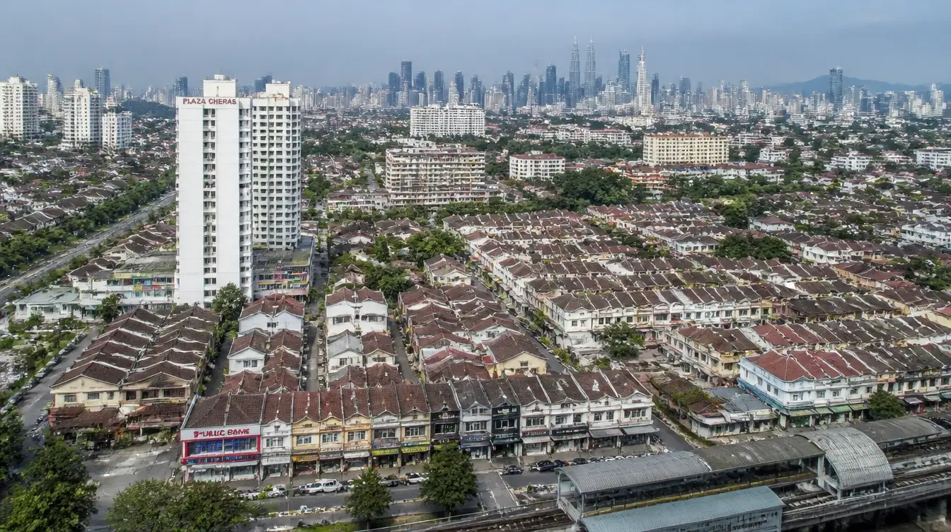An overview of Cheras in Kuala Lumpur, rows of shophouses and housing along the rail line