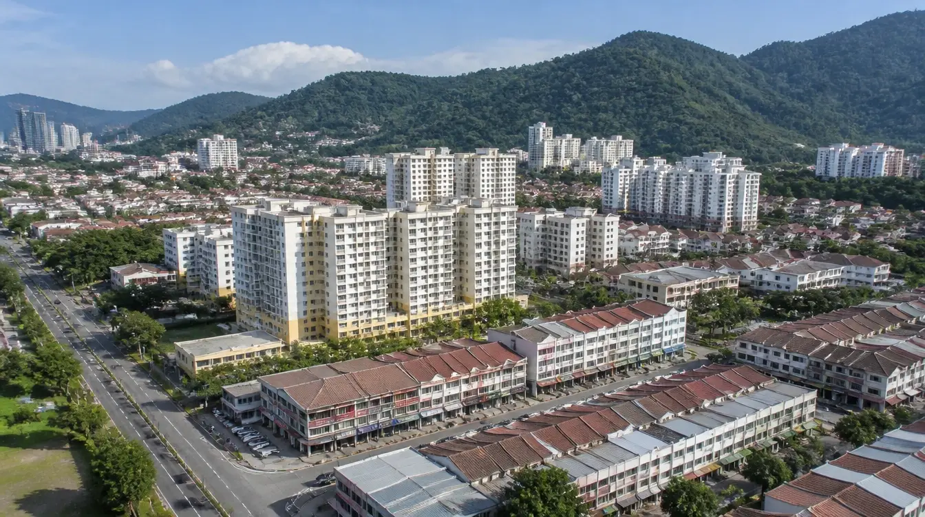 An overview of Bayan Baru in Penang, apartment blocks and shoplot rows below the hills